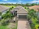 Aerial view of home with beautiful brick driveway, tile roof, and tropical landscaping at 4540 Terrazza Ct, Bradenton, FL 34211