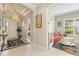 View of entry foyer that leads to a living room with French doors and a bedroom at 4540 Terrazza Ct, Bradenton, FL 34211