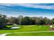 Picturesque golf course with lush green fairways, a challenging sand trap, and scenic views at 4540 Terrazza Ct, Bradenton, FL 34211