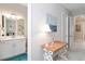 A light, bright hallway gives views of a bathroom and bedroom and has a lovely wooden table at 4540 Terrazza Ct, Bradenton, FL 34211