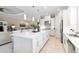 Modern kitchen with white cabinetry, quartz countertops, stainless appliances, and a large island at 4540 Terrazza Ct, Bradenton, FL 34211