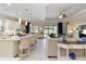 Bright kitchen with stainless appliances, island with seating, and an open floor plan at 4540 Terrazza Ct, Bradenton, FL 34211