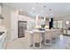 Open-concept kitchen featuring an island with seating, stainless appliances and tile flooring at 4540 Terrazza Ct, Bradenton, FL 34211