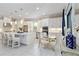 Modern kitchen with stainless appliances, bright white cabinetry and an island with seating at 4540 Terrazza Ct, Bradenton, FL 34211