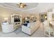 Bright living room with white furniture, blue accents, and tile flooring, offering an open and airy atmosphere at 4540 Terrazza Ct, Bradenton, FL 34211