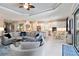 Open-concept living room with neutral tones, white cabinetry and tile flooring at 4540 Terrazza Ct, Bradenton, FL 34211