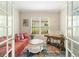 Cozy home office with bright window, desk, sofa, colorful rug, and French doors for privacy at 4540 Terrazza Ct, Bradenton, FL 34211