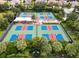 Aerial view of well-maintained pickleball courts with shade and seating, providing an inviting space for recreation at 4540 Terrazza Ct, Bradenton, FL 34211