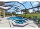 Screened-in pool and spa feature tile accents, water feature, and a beautiful golf course view at 4540 Terrazza Ct, Bradenton, FL 34211