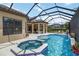 Screened-in pool and spa feature tile accents and seating area with beautiful views at 4540 Terrazza Ct, Bradenton, FL 34211