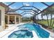 Inviting pool and spa area with a screened enclosure and view of the lush green golf course at 4540 Terrazza Ct, Bradenton, FL 34211