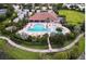 Aerial view showcases the community pool, spa, and beautifully landscaped surroundings with walking paths at 4540 Terrazza Ct, Bradenton, FL 34211