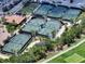 Aerial view of tennis courts, showcasing the community's recreational amenities and meticulously maintained landscaping at 4540 Terrazza Ct, Bradenton, FL 34211