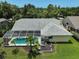 Aerial view of the backyard with a screened-in pool, beautiful lawn and canal at 4733 Spring Meadow Ln, Sarasota, FL 34233