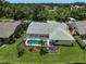 Aerial view of the home's backyard, showcasing the pool, lanai, landscaping and well-manicured lawn at 4733 Spring Meadow Ln, Sarasota, FL 34233