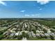 High aerial view of the community showcasing lovely homes surrounded by mature trees and canals at 4733 Spring Meadow Ln, Sarasota, FL 34233