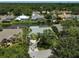 Aerial view showing property with water access, pool and surrounded by mature trees at 4733 Spring Meadow Ln, Sarasota, FL 34233
