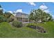 Backyard showcasing a screened-in pool area, landscaping and an oasis at 4733 Spring Meadow Ln, Sarasota, FL 34233