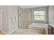 Bathroom featuring a walk-in shower, soaking tub, and neutral tile flooring at 4733 Spring Meadow Ln, Sarasota, FL 34233
