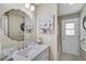 Bathroom features a vanity with a marble countertop, a modern mirror, updated lighting, and a walk-in shower at 4733 Spring Meadow Ln, Sarasota, FL 34233