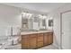 Bright bathroom featuring a dual sink vanity, framed mirrors and neutral color palette at 4733 Spring Meadow Ln, Sarasota, FL 34233
