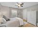 Serene bedroom with a neutral color palette, plush bedding, a window, and a storage cabinet at 4733 Spring Meadow Ln, Sarasota, FL 34233