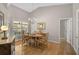 Bright dining room with chandelier, wood floors, large window, and seating for six at 4733 Spring Meadow Ln, Sarasota, FL 34233