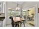 Dining room with an adjacent sunroom featuring sliding glass doors and views of the pool and backyard at 4733 Spring Meadow Ln, Sarasota, FL 34233