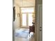 Bright foyer featuring tile flooring, a stylish rug, console table, and decorative lighting, making a great first impression at 4733 Spring Meadow Ln, Sarasota, FL 34233