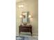 Foyer featuring a decorative table with lamps, a mirror, and a stylish rug, creating a welcoming atmosphere at 4733 Spring Meadow Ln, Sarasota, FL 34233