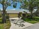 Home's exterior featuring a well-maintained yard, stone accents and driveway at 4733 Spring Meadow Ln, Sarasota, FL 34233