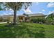 Charming home featuring lush landscaping, stone accents, and a well-manicured lawn, creating inviting curb appeal at 4733 Spring Meadow Ln, Sarasota, FL 34233