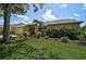 Well-manicured lawn and garden beds highlight this single-story house with a two-car garage at 4733 Spring Meadow Ln, Sarasota, FL 34233
