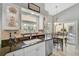 Well-lit kitchen featuring granite countertops, a table with chairs, and a sliding glass door at 4733 Spring Meadow Ln, Sarasota, FL 34233