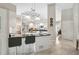 Open kitchen boasts a breakfast bar, white cabinets, stainless steel appliances, and pendant lighting at 4733 Spring Meadow Ln, Sarasota, FL 34233