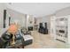 The open living room features neutral walls, travertine floors, a fireplace, and built-in shelves at 4733 Spring Meadow Ln, Sarasota, FL 34233