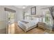 Bright bedroom with a view of the pool area, light wood flooring, and access to the outdoor space at 4733 Spring Meadow Ln, Sarasota, FL 34233