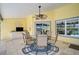 Covered patio with dining set, ceiling fan, outdoor lighting, and a view of the pool at 4733 Spring Meadow Ln, Sarasota, FL 34233