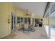 Spacious covered patio features a dining area, ceiling fan and tiled flooring at 4733 Spring Meadow Ln, Sarasota, FL 34233