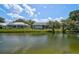 Peaceful pond view in the backyard of this home showing nearby screened lanais at 4733 Spring Meadow Ln, Sarasota, FL 34233
