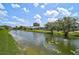 Tranquil pond view with surrounding houses and screened in lanais at 4733 Spring Meadow Ln, Sarasota, FL 34233