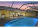 Beautiful pool area with a screened-in enclosure, an outdoor dining area, and patio furniture for relaxing at 4733 Spring Meadow Ln, Sarasota, FL 34233