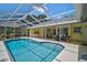 Relaxing pool area featuring yellow house exterior and outdoor living area in background at 4733 Spring Meadow Ln, Sarasota, FL 34233