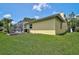 Back of home featuring a screened in lanai with an outside area to enjoy the lush greenery at 4733 Spring Meadow Ln, Sarasota, FL 34233