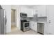 Well-lit kitchen featuring stainless steel appliances and a door to the bathroom at 4796 Duncan Rd, Punta Gorda, FL 33982