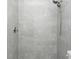 Modern shower featuring gray tiling, sleek fixtures, and a convenient handheld shower head at 4796 Duncan Rd, Punta Gorda, FL 33982