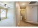 Hallway leading to a bedroom with neutral carpeting and a ceiling fan at 4915 Bookelia Cir, Bradenton, FL 34203