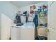Functional laundry area equipped with a washer, dryer, sink, and shelving at 4915 Bookelia Cir, Bradenton, FL 34203