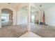 Spacious living room with neutral walls, carpet, and an arched entryway to other rooms at 4915 Bookelia Cir, Bradenton, FL 34203