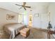 Bedroom with a ceiling fan and view into the main bath at 4915 Bookelia Cir, Bradenton, FL 34203